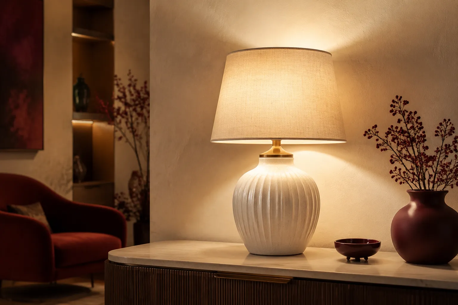 Decorative accent table lamp glowing on a styled console