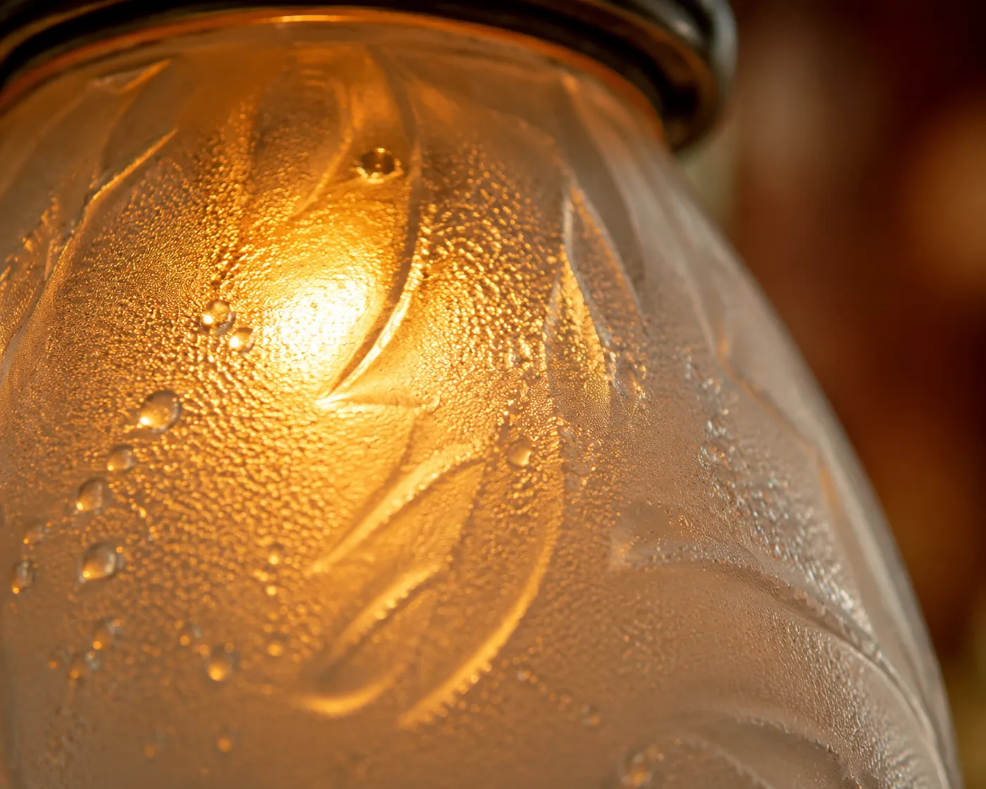 A frosted glass shade diffusing a warm, even glow