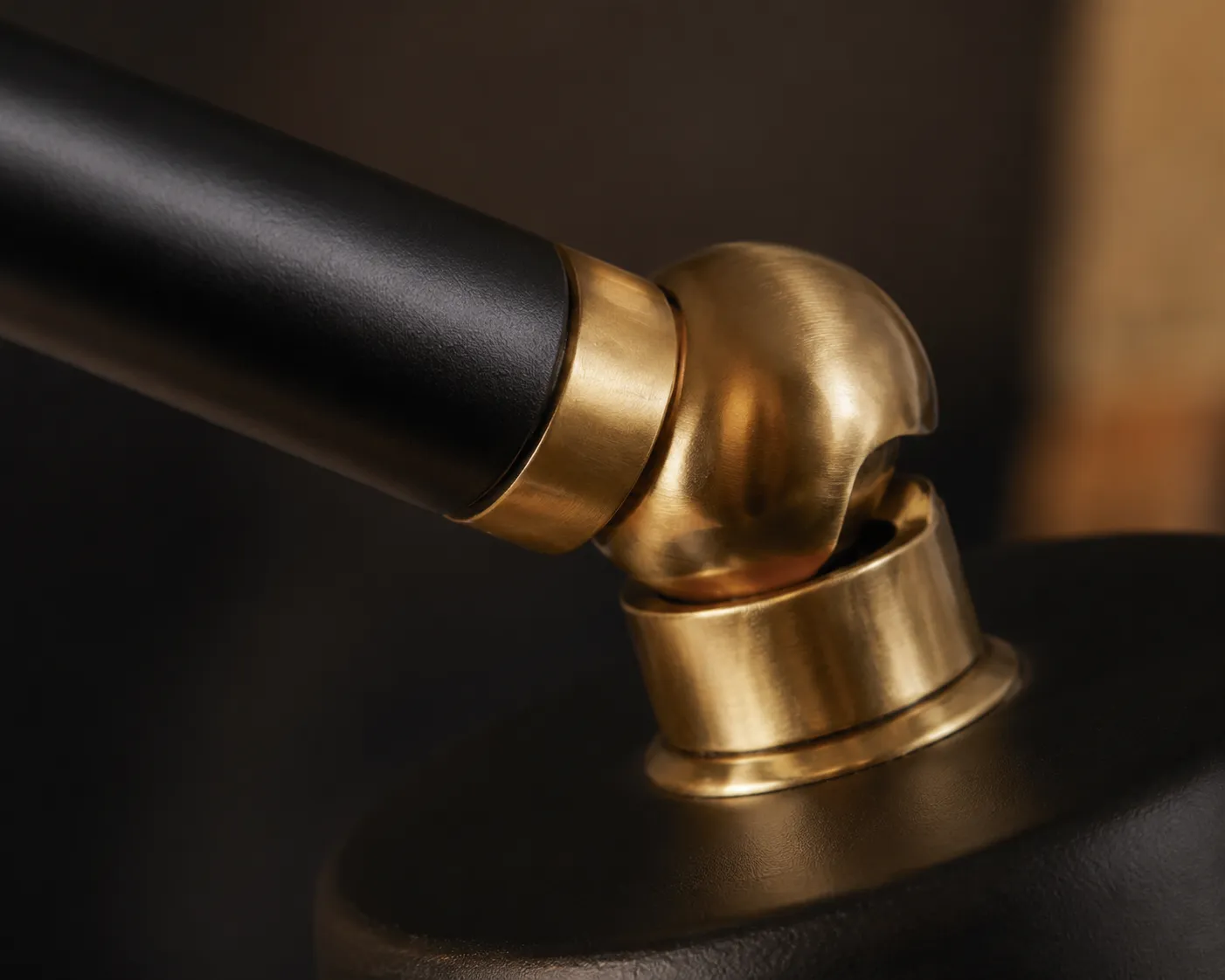 Macro of a powder-coated steel arm meeting a brass joint