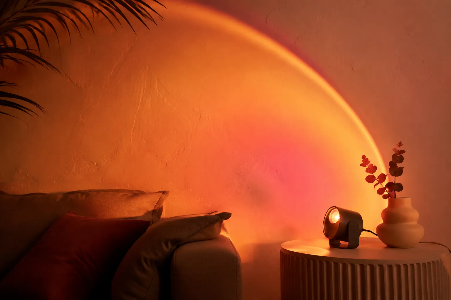 Warm sunset-gradient projection lamp washing a wall in golden light