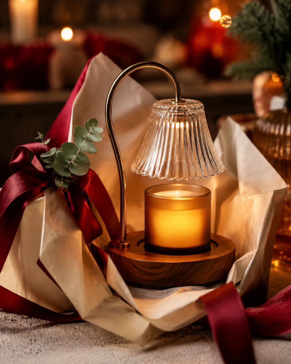 Candle warmer lamp wrapped as a gift with ribbon and greenery