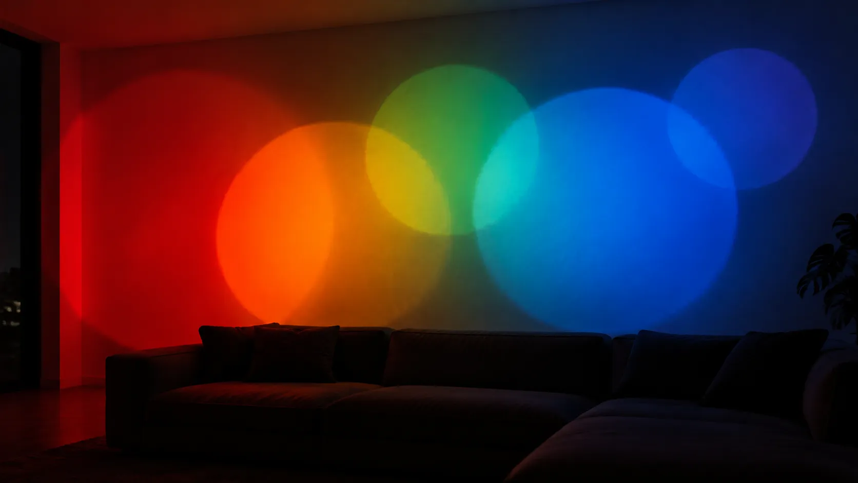 Wide living room wall carrying several overlapping projected circles that blend into a layered colour band