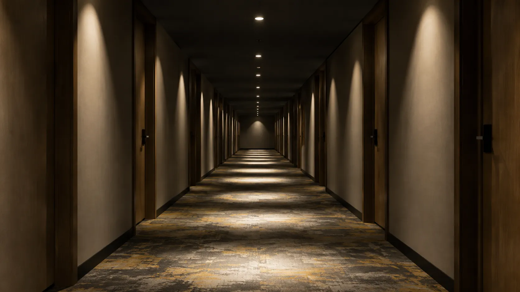 Hotel corridor lit only by recessed downlights, bright pools on the carpet and a dark ceiling above