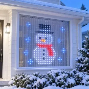 Christmas curtain lights showing a snowman in a front window at dusk