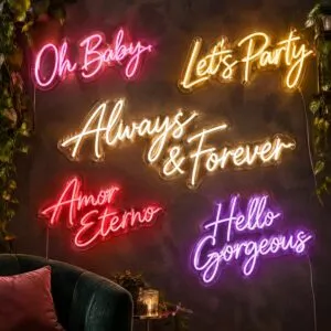 Five custom script LED neon signs on clear cut-to-shape acrylic backing, mounted on a dark textured wall