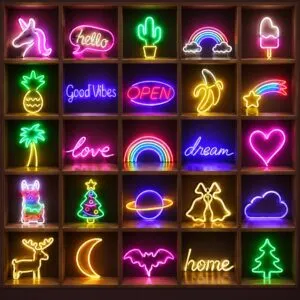 Lit LED neon motif signs in a wooden display grid, including a unicorn, rainbow, cactus, heart, moon and Christmas trees