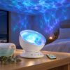 White ocean wave projector lamp with a rippled lens and remote, casting blue water ripples across a bedroom ceiling