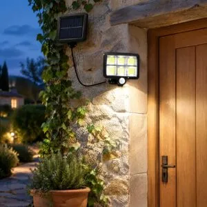 Split solar motion-sensor wall light with a separate solar panel wired to a COB lamp head on a stone wall